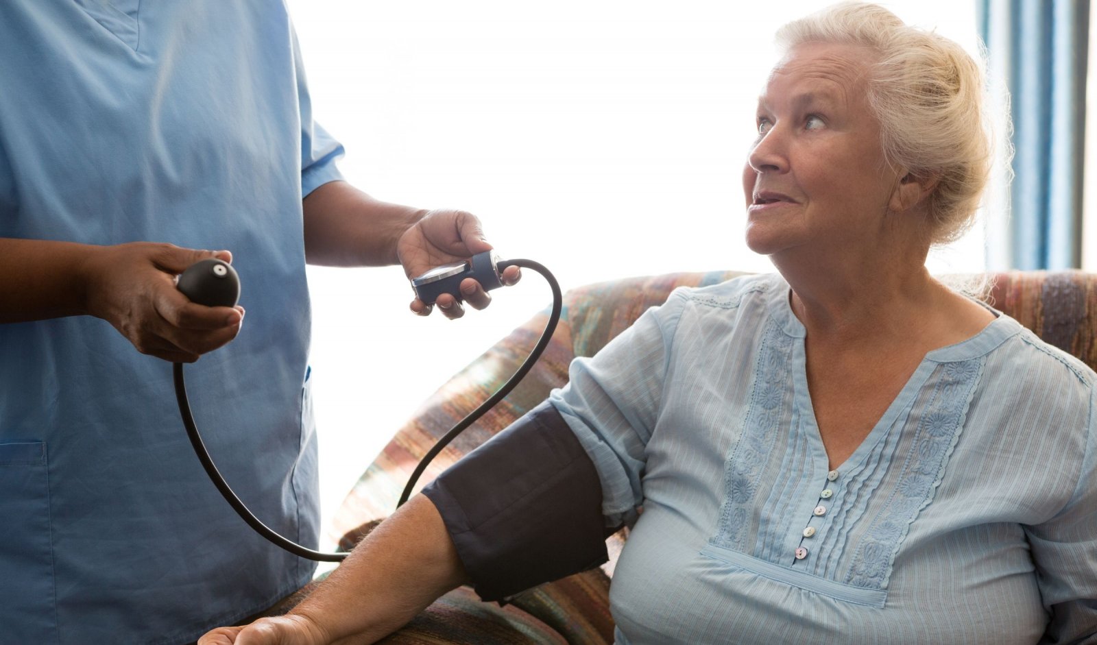 A senior woman gets her blood pressure taken