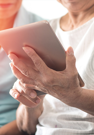 A senior woman uses a tablet