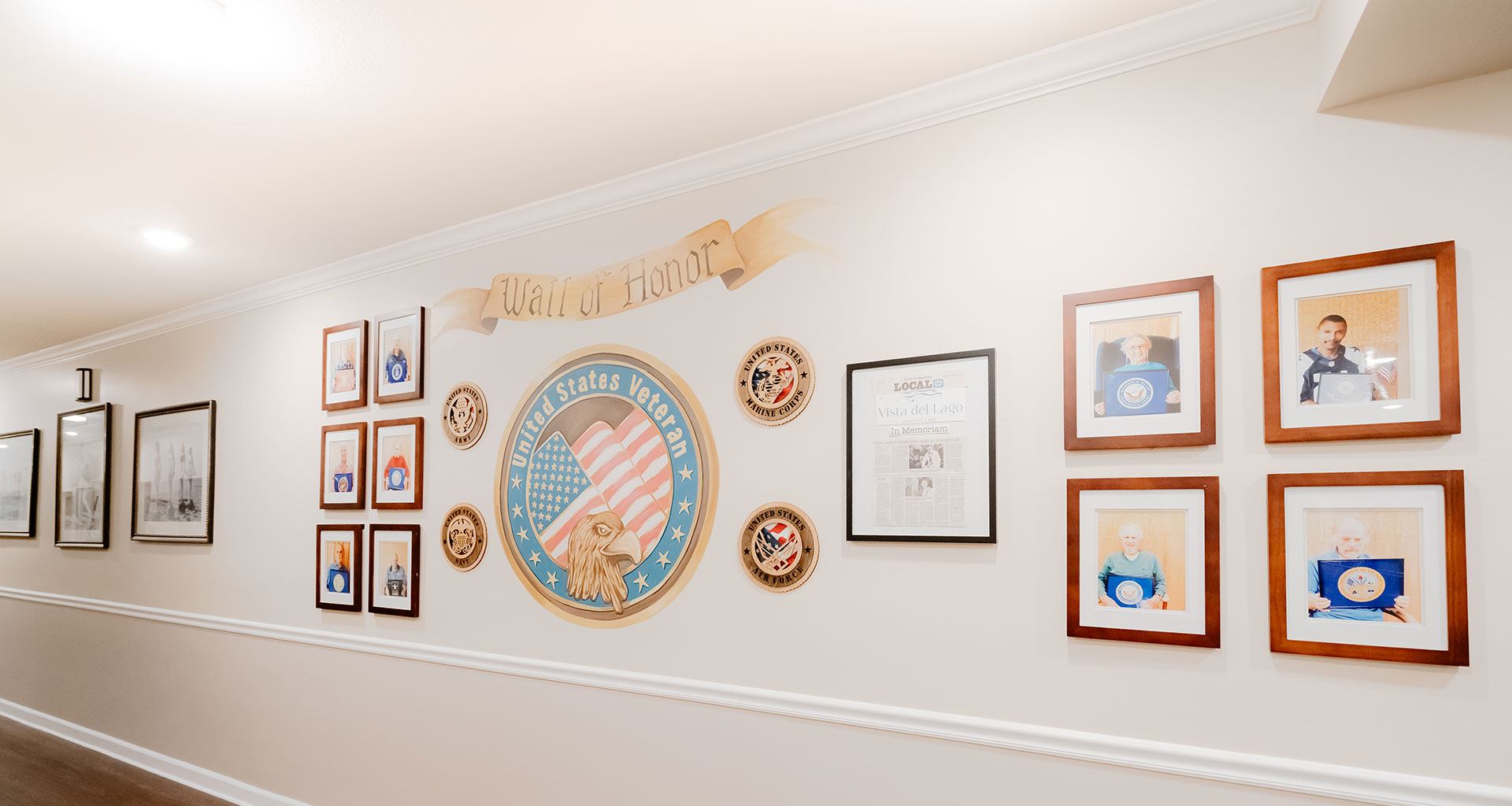 A Wall of Honor featuring veteran's photos and an American flag