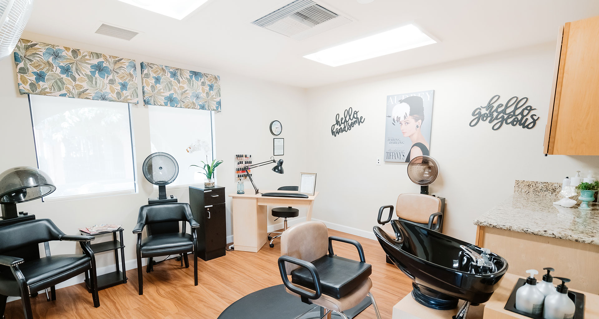 A beauty salon set up with chair and hair dryers