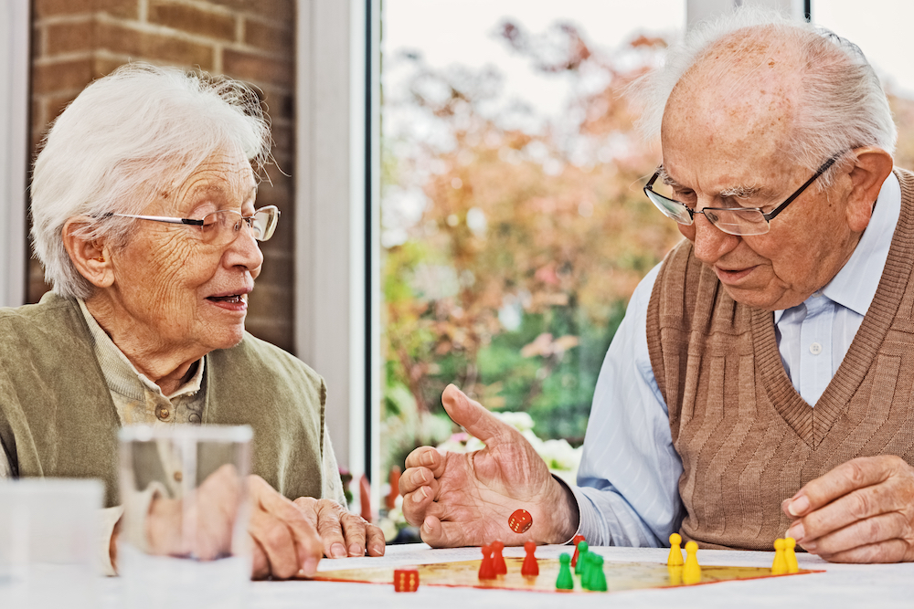 A senior couple playing a board game together