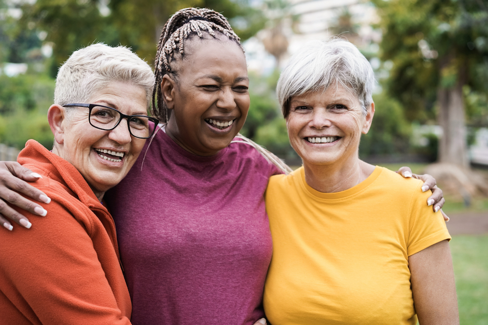 Three senior women smile together